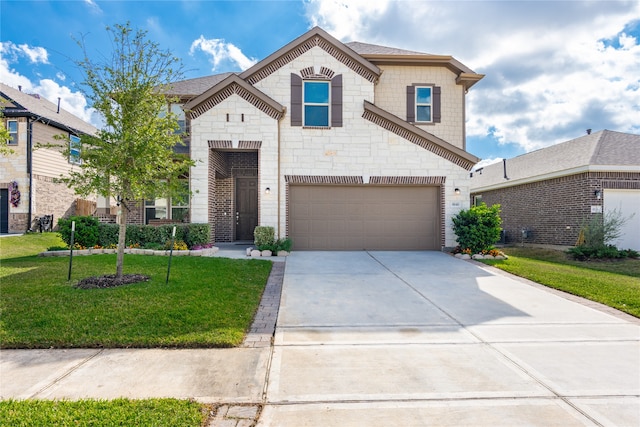 view of front of home with a front lawn and a garage