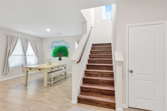 staircase with hardwood / wood-style flooring and plenty of natural light