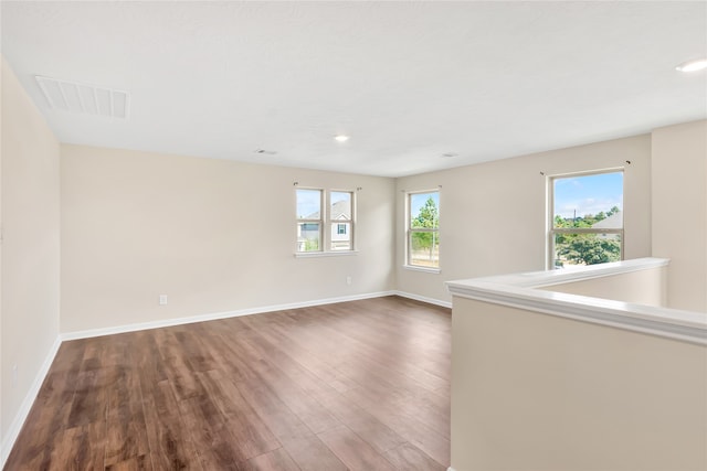 spare room with dark wood-type flooring