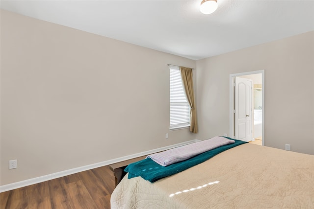 bedroom featuring hardwood / wood-style floors and ensuite bathroom