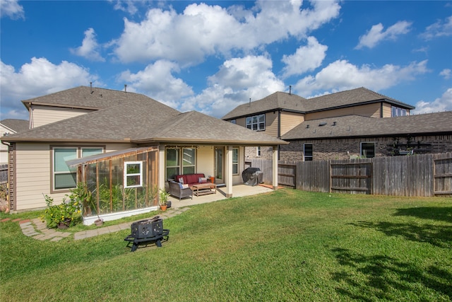 back of property featuring a patio area, a lawn, and an outdoor hangout area