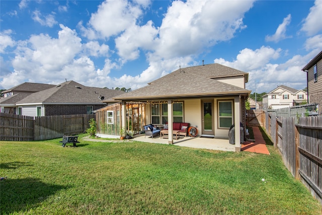 back of house featuring a patio, an outdoor living space, and a lawn