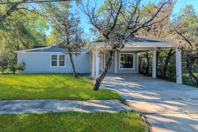 ranch-style house with a carport and a front lawn