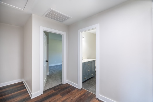 corridor with dark hardwood / wood-style flooring