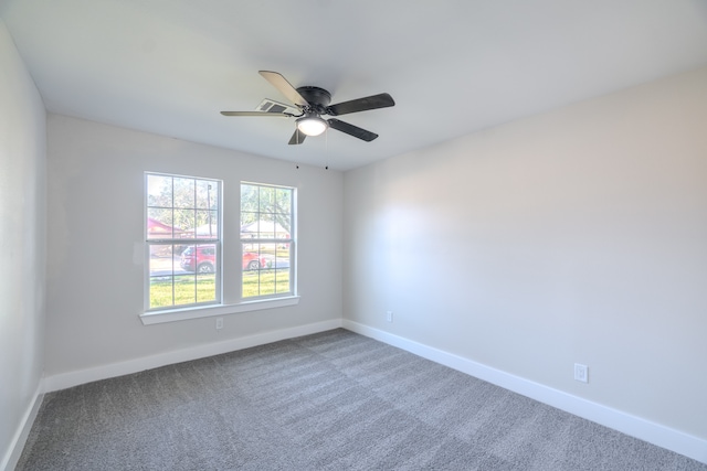 spare room featuring carpet and ceiling fan