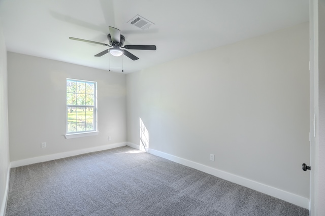 carpeted spare room featuring ceiling fan