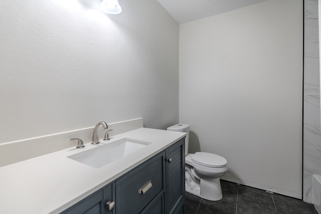 bathroom with tile patterned flooring, vanity, and toilet