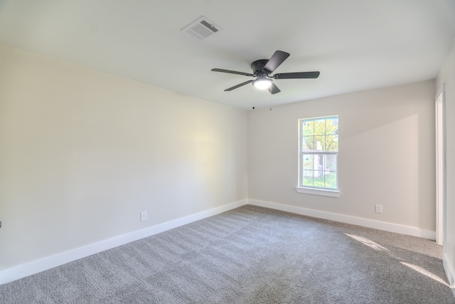 carpeted spare room featuring ceiling fan