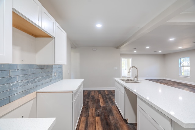 kitchen with tasteful backsplash, a kitchen island with sink, sink, dark hardwood / wood-style floors, and white cabinetry