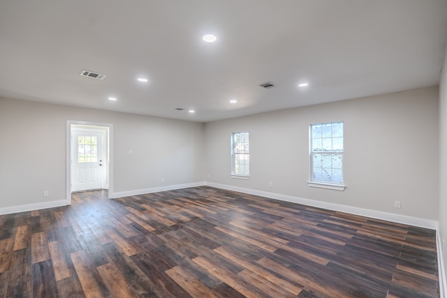 empty room with dark hardwood / wood-style flooring