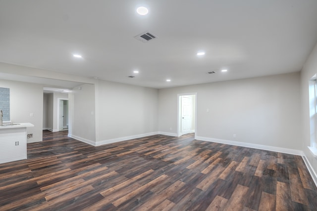 unfurnished room with dark wood-type flooring