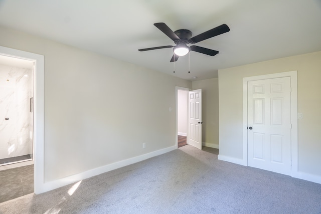 unfurnished bedroom with ceiling fan and carpet floors