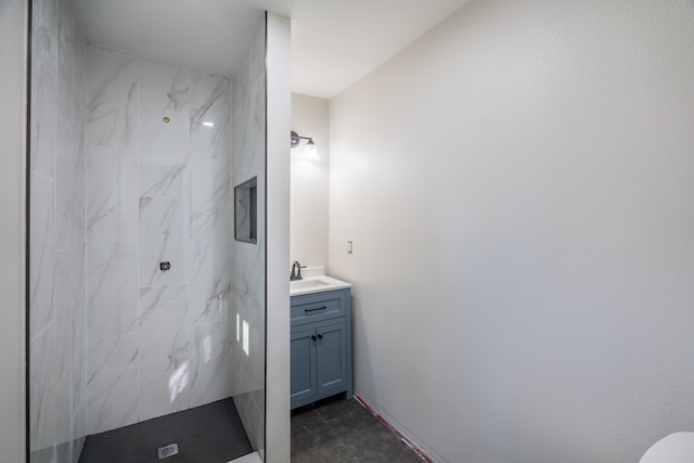 bathroom with vanity and a tile shower