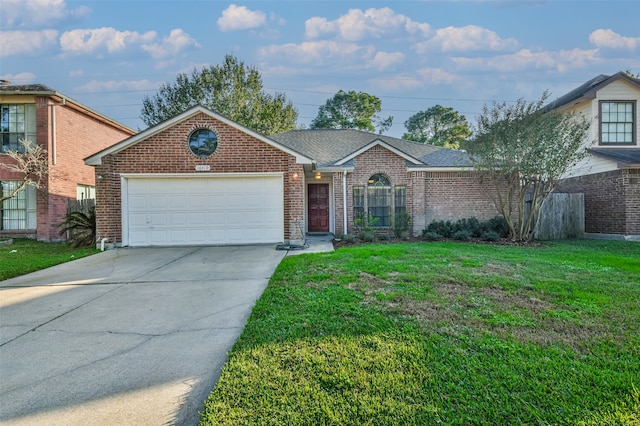 view of front of property with a garage and a front lawn