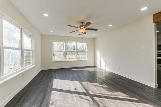 empty room featuring ceiling fan and dark hardwood / wood-style flooring