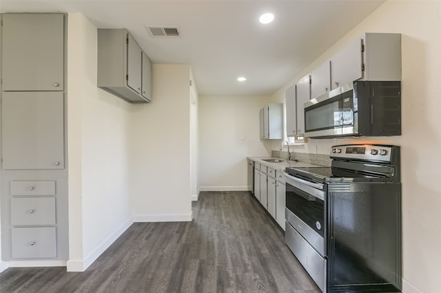 kitchen with appliances with stainless steel finishes, dark hardwood / wood-style floors, sink, and gray cabinets