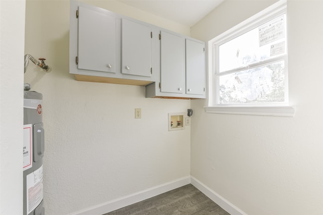 clothes washing area featuring cabinets, water heater, dark hardwood / wood-style floors, and hookup for a washing machine