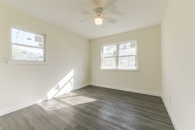 unfurnished room featuring dark wood-type flooring and ceiling fan