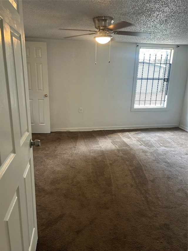 spare room with ceiling fan, a textured ceiling, and carpet floors