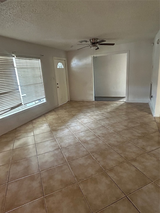 entrance foyer with ceiling fan and a textured ceiling