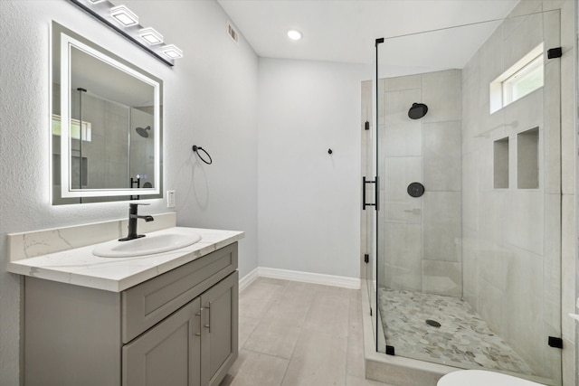 bathroom featuring vanity, an enclosed shower, toilet, and tile patterned flooring