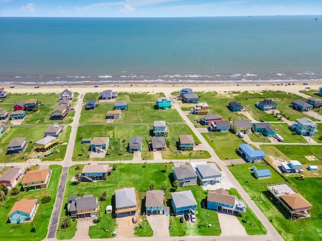 drone / aerial view with a water view and a view of the beach