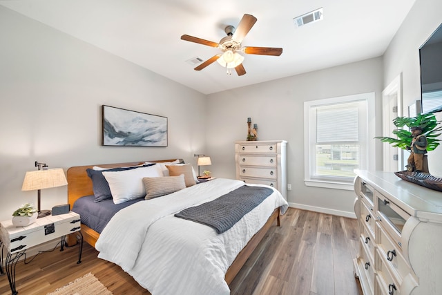 bedroom with ceiling fan and light wood-type flooring