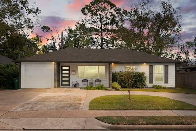 view of front of property with a yard and a garage