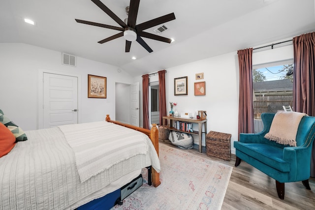 bedroom featuring ceiling fan, vaulted ceiling, and light hardwood / wood-style floors