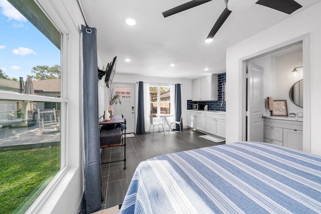 bedroom with dark hardwood / wood-style floors, ensuite bathroom, and ceiling fan