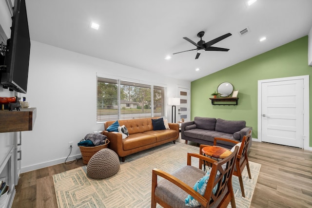 living room featuring light hardwood / wood-style floors, lofted ceiling, and ceiling fan