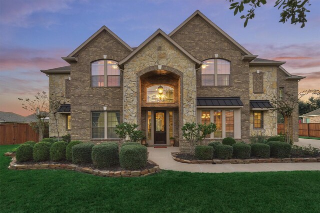 french provincial home featuring a yard