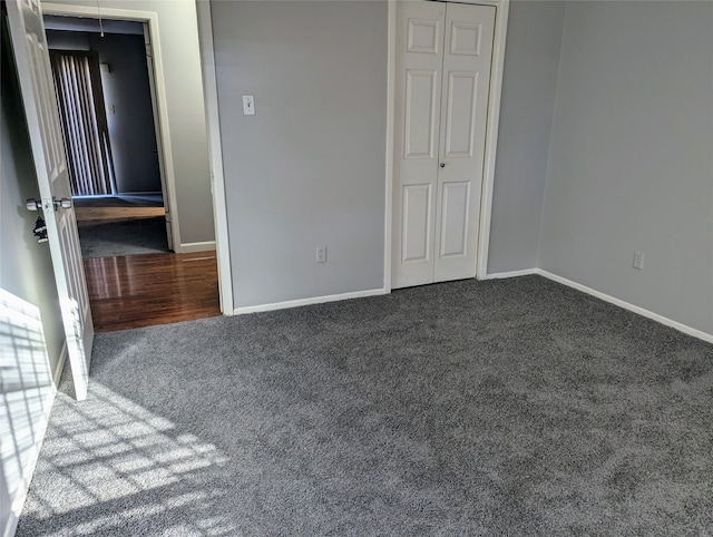 unfurnished bedroom featuring carpet and a closet