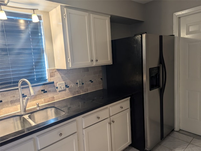 kitchen with sink, backsplash, hanging light fixtures, white cabinets, and stainless steel fridge with ice dispenser