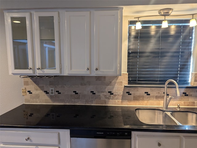 kitchen with white cabinetry, sink, stainless steel dishwasher, and decorative light fixtures