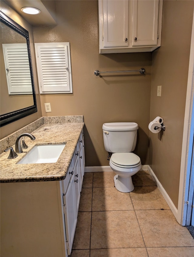 bathroom featuring vanity, toilet, and tile patterned flooring