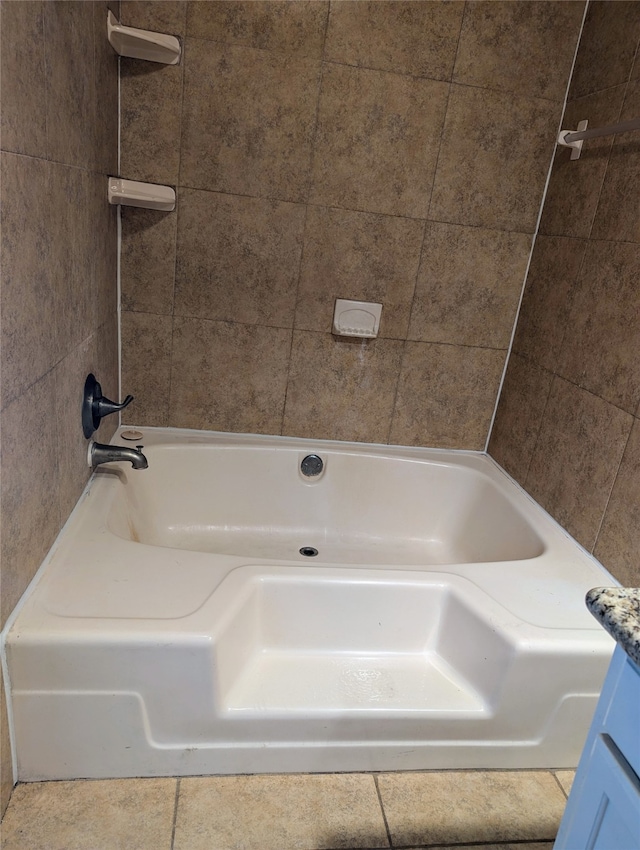 bathroom featuring vanity and tiled shower / bath