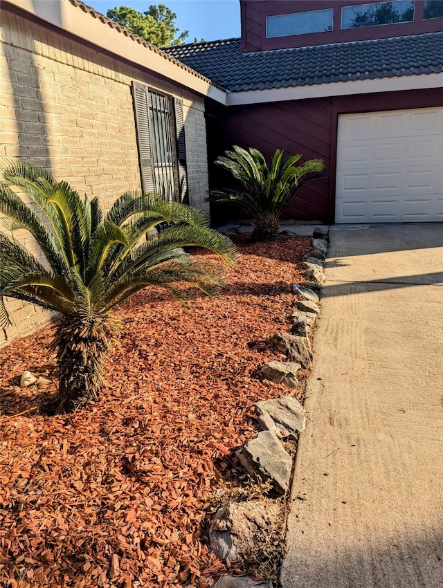 view of side of home featuring a garage