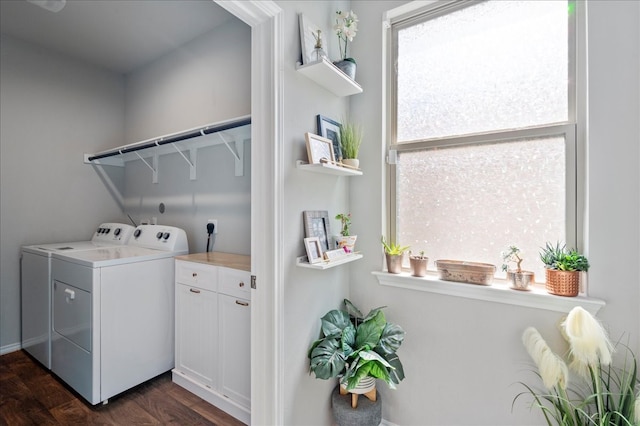 washroom featuring dark hardwood / wood-style flooring and washing machine and clothes dryer