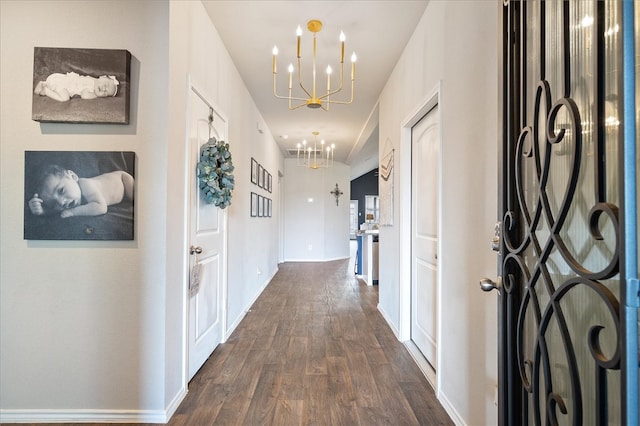 hall featuring dark hardwood / wood-style flooring and a notable chandelier