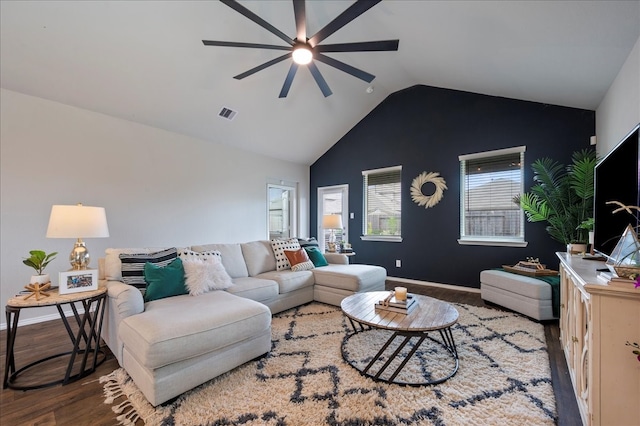 living room with hardwood / wood-style floors, ceiling fan, and vaulted ceiling