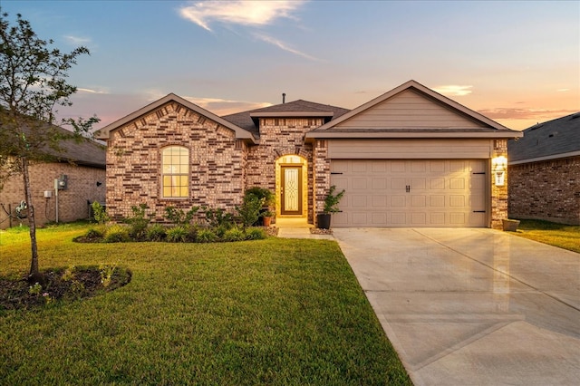 view of front of house featuring a garage and a lawn