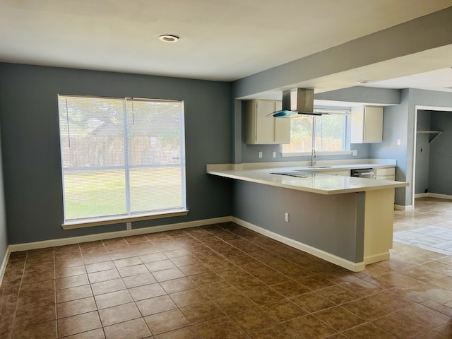 kitchen with island range hood, dishwasher, dark tile patterned flooring, kitchen peninsula, and sink