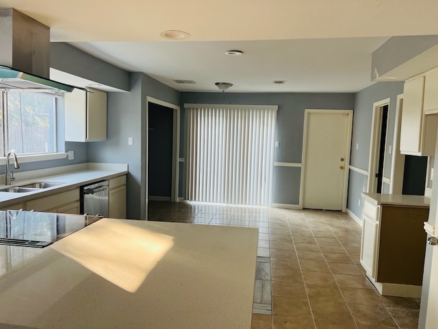 kitchen with light tile patterned floors, sink, and stainless steel dishwasher