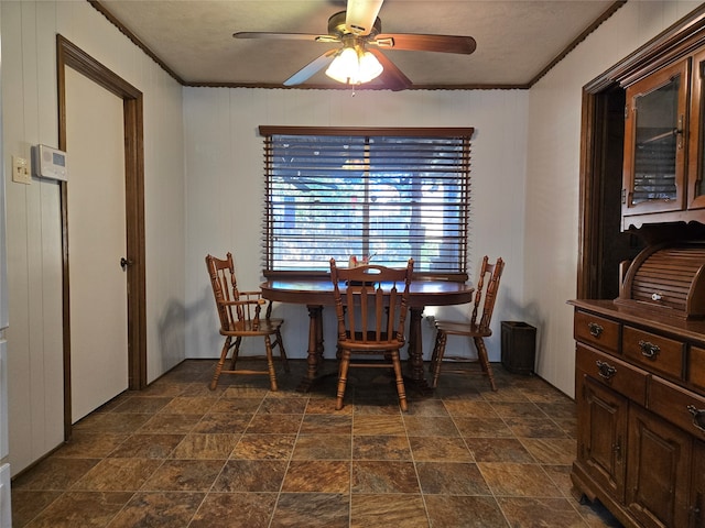 dining space featuring ceiling fan and ornamental molding