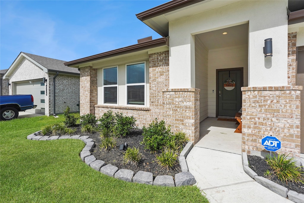 doorway to property with a lawn and a garage