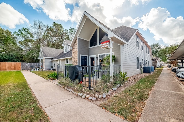 view of front of property featuring central AC and a front lawn