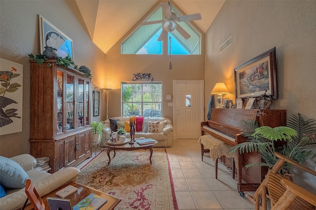 living room with ceiling fan, high vaulted ceiling, and light tile patterned floors