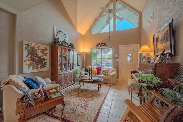 living room featuring ceiling fan, high vaulted ceiling, light tile patterned floors, and plenty of natural light