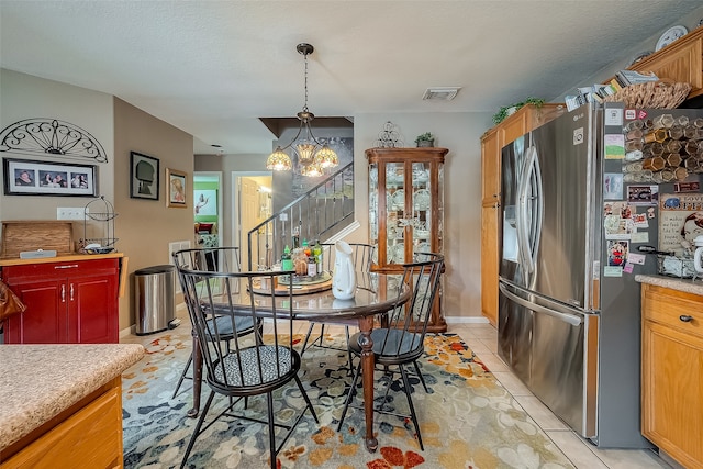 dining room featuring a notable chandelier and light tile patterned floors